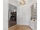 Entryway featuring a decorative light fixture, arched doorway and travertine floors at 2 Yorkridge Ct, Henderson, NV 89052