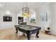 Spacious game room with pool table, backyard views, and open sight-lines to living room at 2 Yorkridge Ct, Henderson, NV 89052