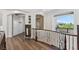 Bright hallway featuring wood floors, decorative iron railing, and archways leading to other rooms at 2 Yorkridge Ct, Henderson, NV 89052