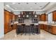 Spacious kitchen with custom wood cabinetry, granite countertops, and a large center island with bar seating at 2 Yorkridge Ct, Henderson, NV 89052