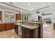 Kitchen featuring custom wood cabinetry, granite countertops, stainless steel appliances, and a center island sink at 2 Yorkridge Ct, Henderson, NV 89052
