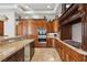 View of the kitchen with custom cabinetry, granite countertops, stainless steel appliances, and cooktop stove at 2 Yorkridge Ct, Henderson, NV 89052