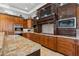 Kitchen with custom wood cabinetry, granite countertops, stainless steel appliances, and cooktop stove at 2 Yorkridge Ct, Henderson, NV 89052