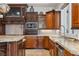 Close up of the kitchen showing custom cabinetry, granite countertops, stainless steel appliances and tile backsplash at 2 Yorkridge Ct, Henderson, NV 89052
