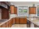 Kitchen featuring custom wood cabinetry, granite countertops, stainless steel appliances, and a large window at 2 Yorkridge Ct, Henderson, NV 89052