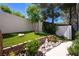 Landscaped garden featuring a Buddha statue, stone borders, decorative rocks, and lush greenery at 2 Yorkridge Ct, Henderson, NV 89052