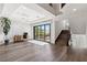 Bright living room featuring wood floors, white trim, and modern sliding glass doors at 2 Yorkridge Ct, Henderson, NV 89052