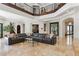 Spacious living room with soaring ceilings, elegant staircase, marble floors, and a comfortable sectional sofa at 2 Yorkridge Ct, Henderson, NV 89052