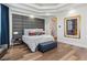Cozy main bedroom with a decorative headboard, wood floors, and bench at 2 Yorkridge Ct, Henderson, NV 89052