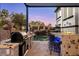 Well-equipped outdoor kitchen area overlooking the pool with rock water feature at 2 Yorkridge Ct, Henderson, NV 89052