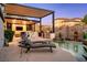 Backyard featuring a built-in kitchen, outdoor seating, and a pool for relaxation and entertainment at 2 Yorkridge Ct, Henderson, NV 89052