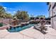 Inviting backyard pool featuring a rock waterfall, integrated spa, and poolside lounge chairs at 2 Yorkridge Ct, Henderson, NV 89052