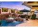 Beautiful pool featuring a waterfall, accent lighting, and lush landscaping for a luxurious outdoor living space at 2 Yorkridge Ct, Henderson, NV 89052