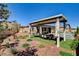 Spacious backyard featuring a covered patio, outdoor dining space, manicured landscaping, and a refreshing pool at 21 Reverie Heights Ave, Henderson, NV 89011