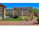 Professionally landscaped backyard with covered patio, lush lawn, and mature trees, offering a serene outdoor retreat at 21 Reverie Heights Ave, Henderson, NV 89011