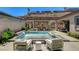 Lush backyard including a swimming pool, patio and lounge chairs at 21 Reverie Heights Ave, Henderson, NV 89011