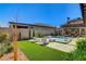 Backyard oasis with a pool, lounge chairs, and lush landscaping at 21 Reverie Heights Ave, Henderson, NV 89011
