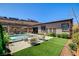 Backyard features a sparkling pool, grassy area, and covered patio for outdoor dining at 21 Reverie Heights Ave, Henderson, NV 89011