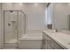 The bathroom features a glass-enclosed shower and a soaking tub with a vanity at 21 Reverie Heights Ave, Henderson, NV 89011