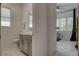 A modern bathroom featuring a vanity and fixtures, with a peek into the connected home office at 21 Reverie Heights Ave, Henderson, NV 89011