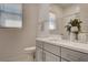Clean bathroom with modern vanity, sleek toilet, and window with natural light at 21 Reverie Heights Ave, Henderson, NV 89011