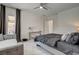 The primary bedroom has a large bed, seating, and outside access to the patio at 21 Reverie Heights Ave, Henderson, NV 89011