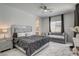 The main bedroom has a ceiling fan and a seating area with a large window at 21 Reverie Heights Ave, Henderson, NV 89011