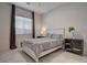 Comfortable bedroom with tile flooring, a queen bed, and neutral decor at 21 Reverie Heights Ave, Henderson, NV 89011