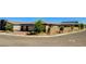Wide angle view of this single-story home featuring a three-car garage and landscaped front yard at 21 Reverie Heights Ave, Henderson, NV 89011