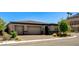 Single-story home featuring a three-car garage and landscaped front yard on a quiet street at 21 Reverie Heights Ave, Henderson, NV 89011