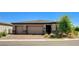 Beautiful single-story home featuring a three-car garage and landscaped front yard with a brick-paved driveway at 21 Reverie Heights Ave, Henderson, NV 89011
