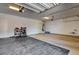 Spacious two car garage with epoxy flooring, storage racks, and utility connections at 21 Reverie Heights Ave, Henderson, NV 89011