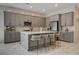 Beautiful kitchen with a large island, counter seating, stainless appliances, and a gray color palette at 21 Reverie Heights Ave, Henderson, NV 89011