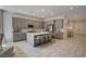Spacious kitchen features gray cabinetry, a marble countertop island with seating, and modern stainless steel appliances at 21 Reverie Heights Ave, Henderson, NV 89011