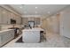 Spacious kitchen with gray cabinetry, stainless steel appliances, a large island with bar seating and marble flooring at 21 Reverie Heights Ave, Henderson, NV 89011