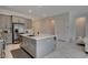 Gorgeous kitchen featuring a large island, counter seating, stainless appliances, and stone countertops at 21 Reverie Heights Ave, Henderson, NV 89011