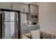 Cozy kitchenette with stainless steel refrigerator, sink, microwave, and gray cabinetry at 21 Reverie Heights Ave, Henderson, NV 89011