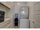 Functional laundry room with a stackable washer and dryer unit at 21 Reverie Heights Ave, Henderson, NV 89011