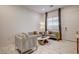 Bright living room with modern marble floors, stylish furniture, and ample natural light at 21 Reverie Heights Ave, Henderson, NV 89011
