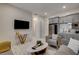 Modern living room with a TV, stylish furniture, wet bar, and access to other areas at 21 Reverie Heights Ave, Henderson, NV 89011