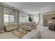 Bright living room featuring stylish furniture, and views of the kitchen and backyard at 21 Reverie Heights Ave, Henderson, NV 89011