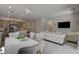 Open concept living and dining area featuring gray cabinetry, a large island, and a decorative wall mounted TV at 21 Reverie Heights Ave, Henderson, NV 89011