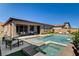 Inviting pool and spa with seamless transition to patio, offering an ideal space for outdoor relaxation and entertainment at 21 Reverie Heights Ave, Henderson, NV 89011