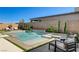Beautiful backyard pool with a waterfall feature, spa, lush landscaping, and plenty of seating areas at 21 Reverie Heights Ave, Henderson, NV 89011