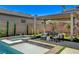 Backyard oasis featuring a sparkling pool, spa, covered dining area, and mature landscaping for ultimate privacy at 21 Reverie Heights Ave, Henderson, NV 89011