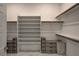 A spacious walk-in closet with shelving units, hanging rods, and drawers to maximize storage at 21 Reverie Heights Ave, Henderson, NV 89011
