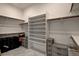 A well-organized walk-in closet with shelving, rods, drawers, and light tile flooring for storage at 21 Reverie Heights Ave, Henderson, NV 89011