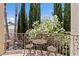 Cozy balcony with a seating area and a serene view of the surrounding greenery at 2112 Preakness Pass, Las Vegas, NV 89117