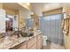 Bathroom featuring a glass vessel sink, granite countertops, and decorative shower curtain at 2112 Preakness Pass, Las Vegas, NV 89117
