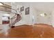 Spacious living room boasting hardwood floors, high ceilings, a staircase, and a modern light fixture at 2112 Preakness Pass, Las Vegas, NV 89117